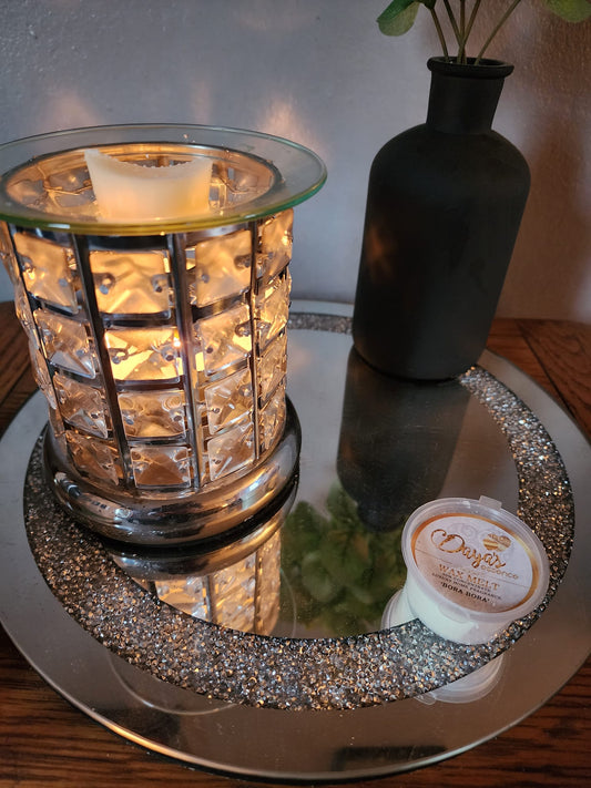 A Daya's Essence wax melt warmer with a Bora Bora scent melt illuminates a diamond pattern on the glass, evoking the sensory experience and emotional connection discussed in this blog post about the link between scent and memory.