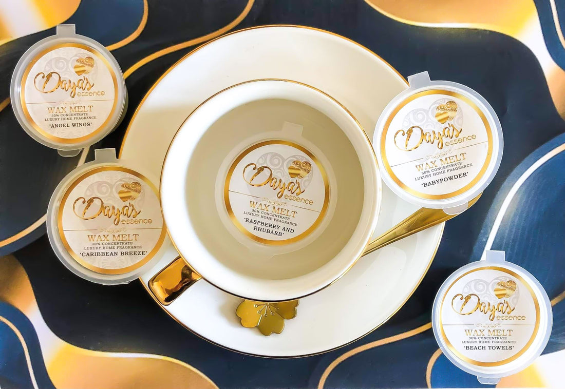 Daya's Essence wax melts in various scents arranged around a teacup and saucer on a decorative tray. blog post goes into is too much fragrance oil in wax melts a health risk? 