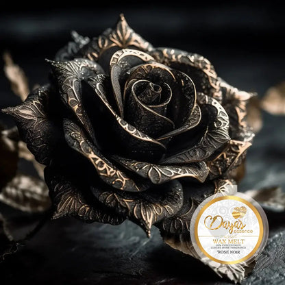 Close-up of a dark, intricately designed rose with gold accents, accompanied by a label reading 'Dayas Essence Wax Melt, Luxury Home Fragrance, Rose Noir'.