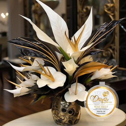 The image shows a luxury home fragrance wax melt concentrate. It is called "Birds of Paradise" and is made by Days. The wax melt is presented with a beautiful floral arrangement of white and gold flowers, likely meant to evoke the fragrance.