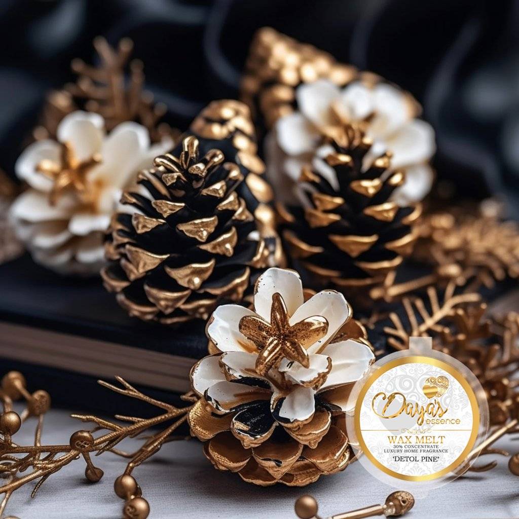 Golden pine cones with white flowers on a black background. Dayas Essence Detol Pine Wax Melt.