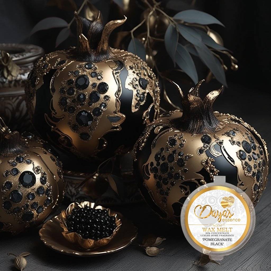  Three decorative black and gold pomegranates adorned with sparkling jewels sit beside a luxurious wax melt labeled "Pomegranate Black" by Daya's Essence.