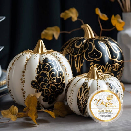 Three white and gold decorative pumpkins sit alongside a "Primwhite" wax melt by Daya's Essence. The wax melt, nestled among autumn leaves, promises a warm and inviting fragrance experience, perfect for the fall season.